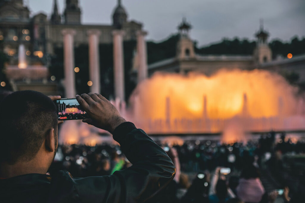 Male traveler taking a photo with a smartphone