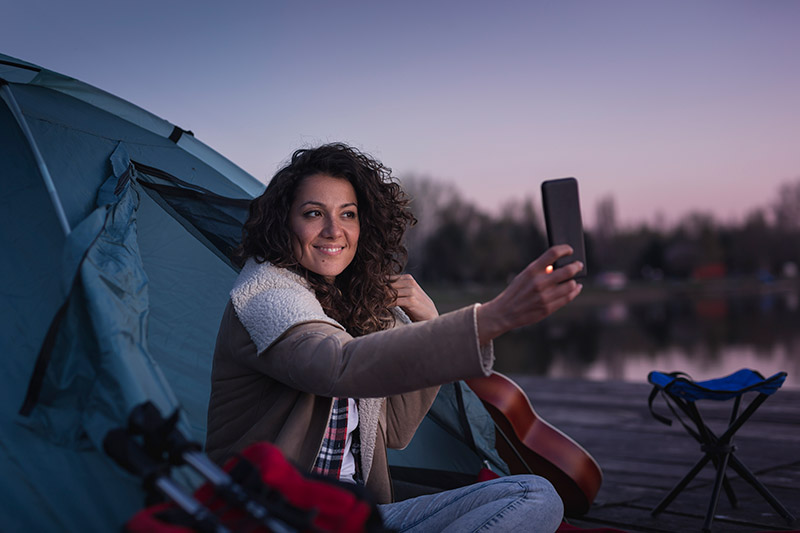 A woman camping and taking a selfie