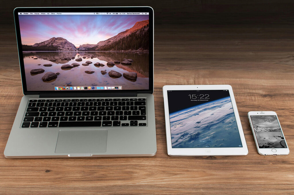 Desk with laptop, tablet, and phone