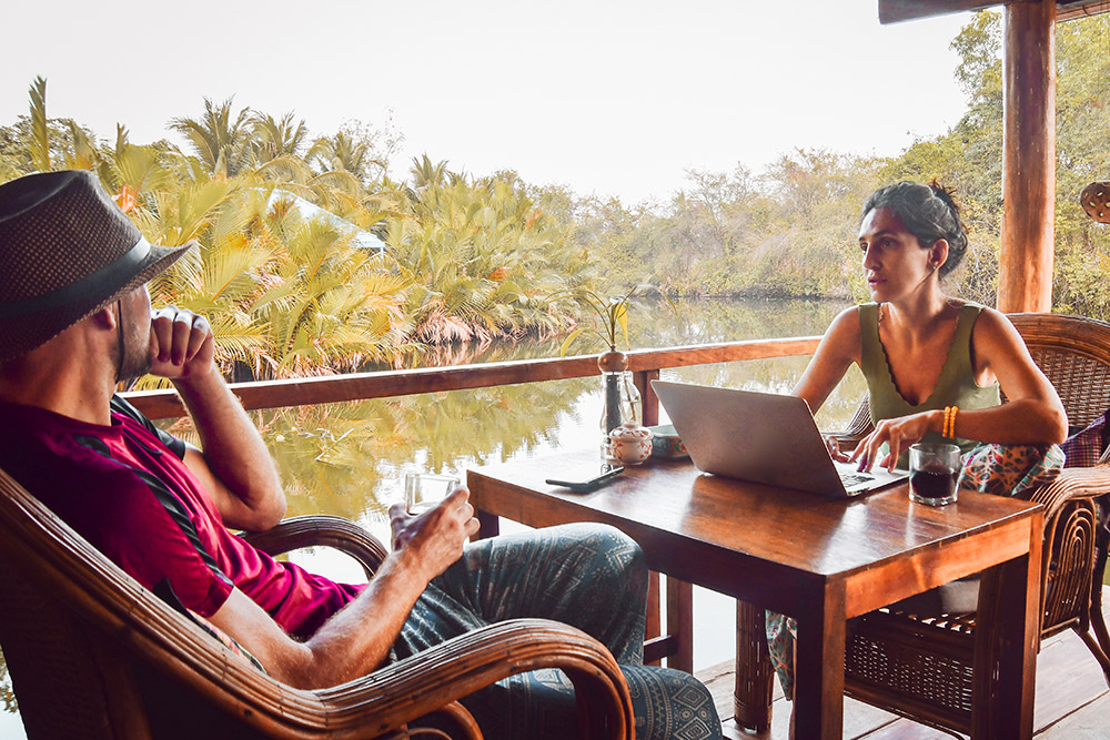 Two digital nomads at an outdoor cafe